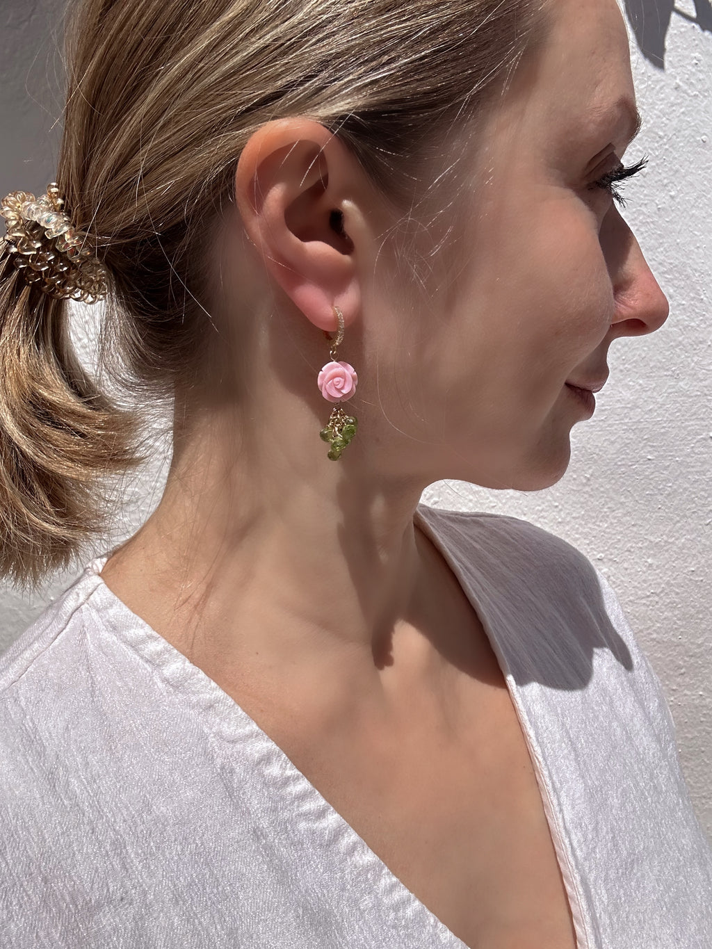 Carved queen conch shell rose and peridot drop earrings