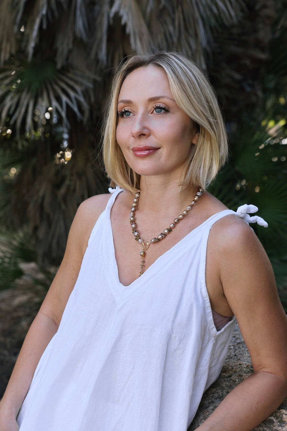 Malva Edison baroque pearl and tourmaline statement necklace worn by a woman
