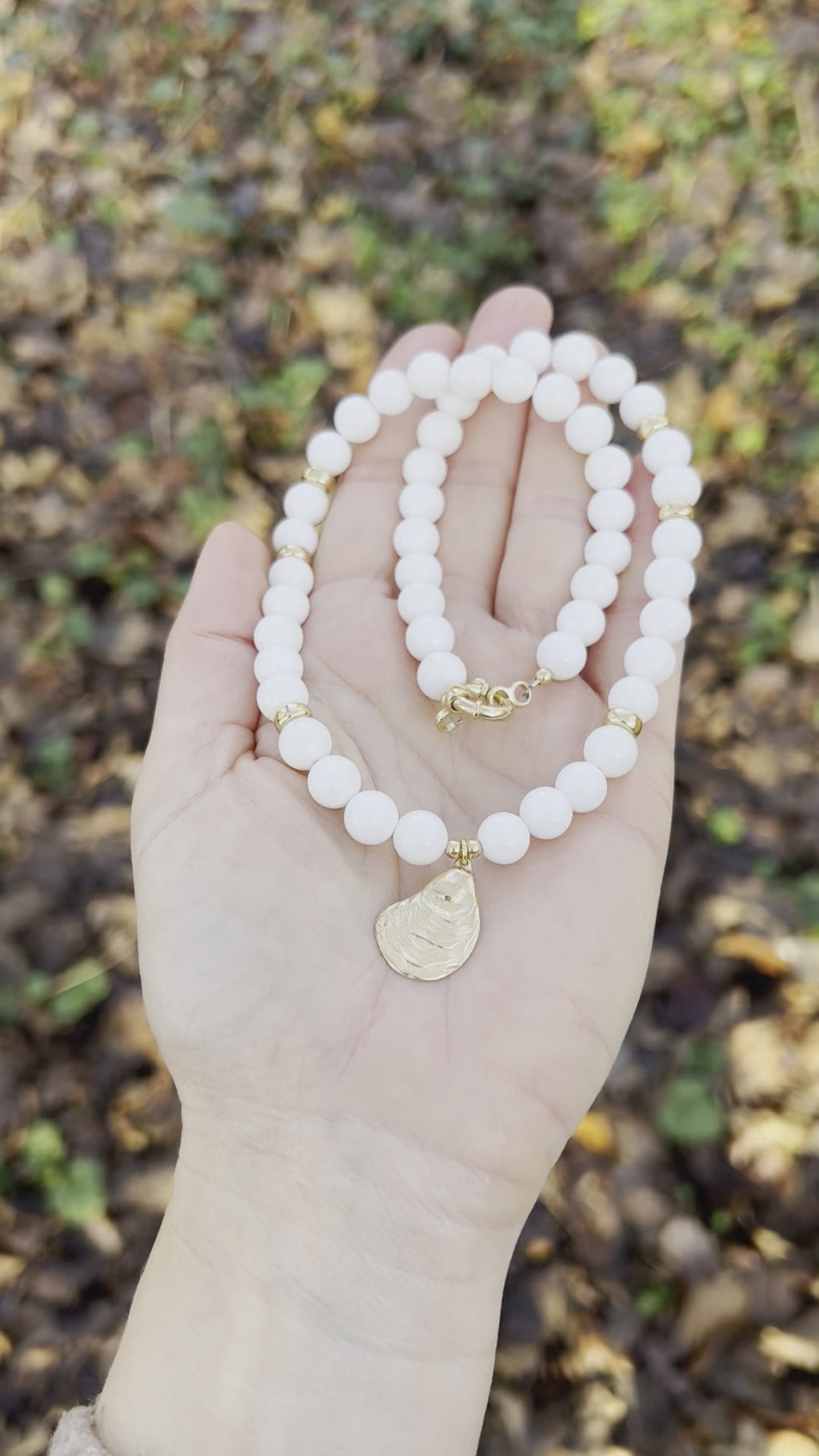 White bead necklace with golden sea shell charm