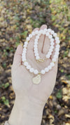 White bead necklace with golden sea shell charm