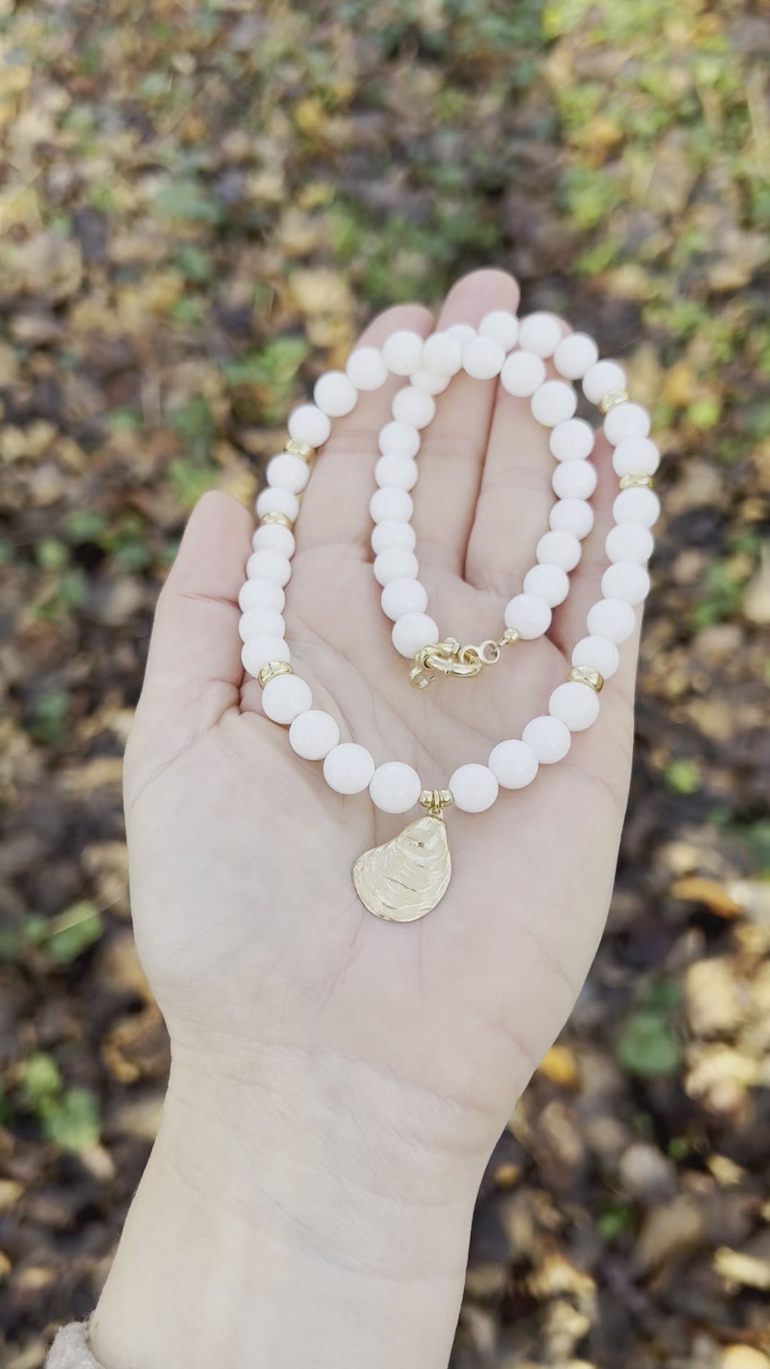 White bead necklace with golden sea shell charm