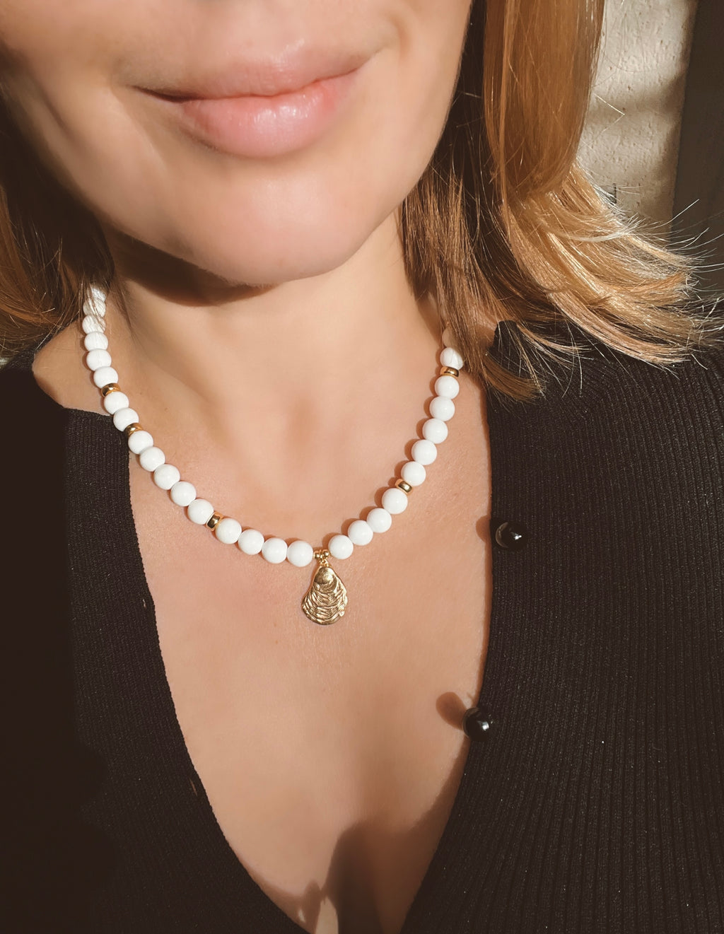 White bead necklace with golden sea shell charm