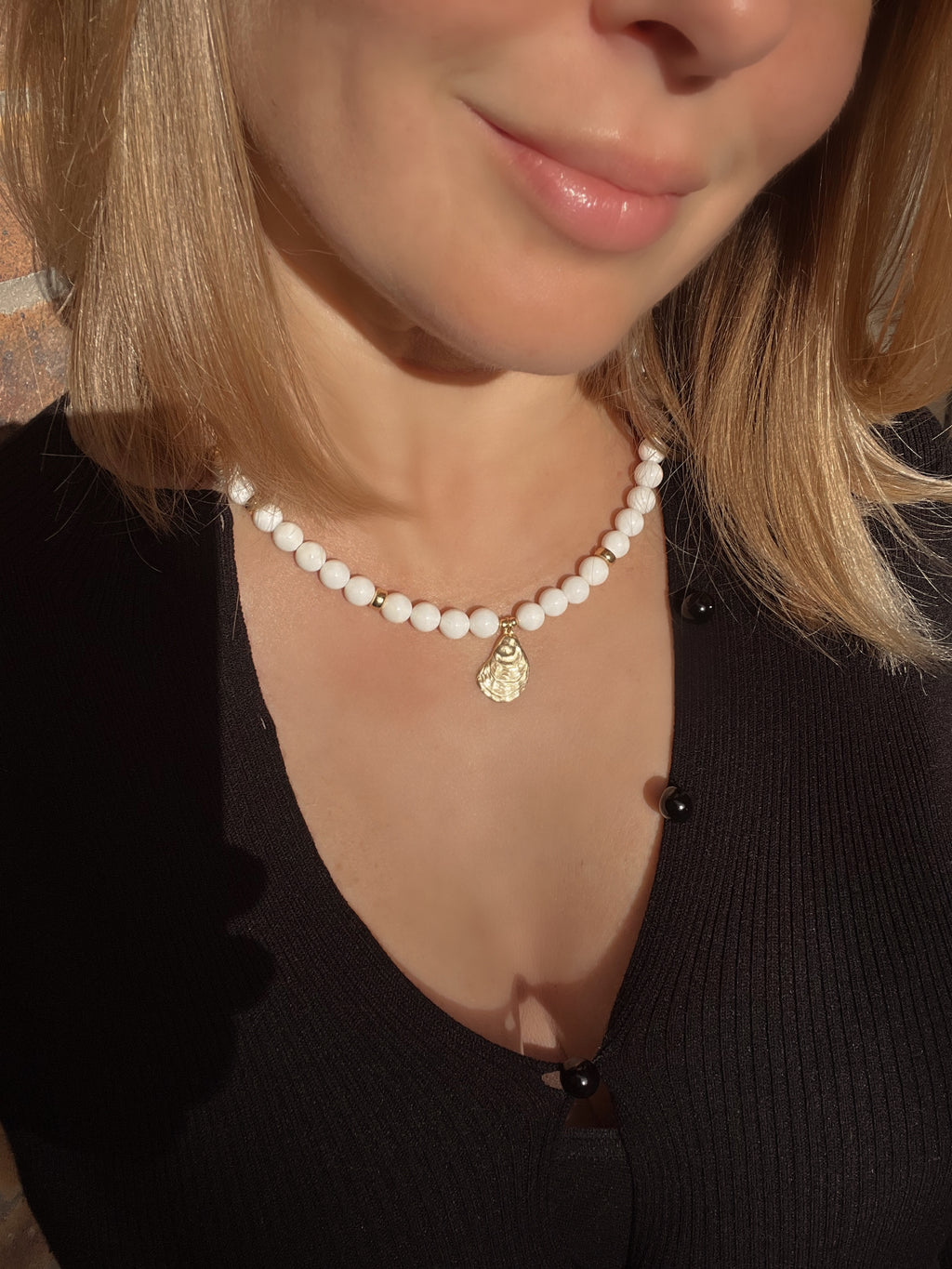 White bead necklace with golden sea shell charm