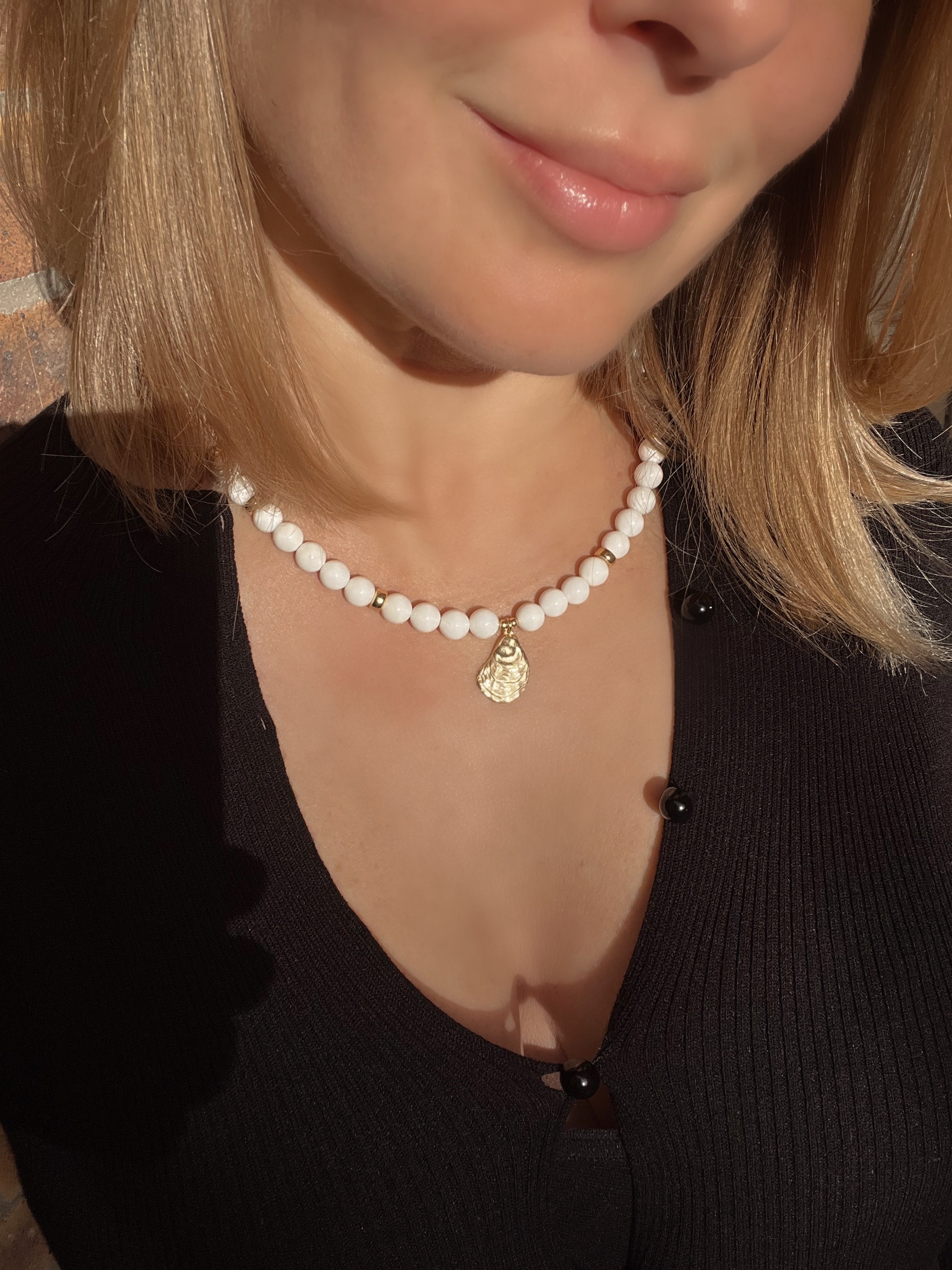 White bead necklace with golden sea shell charm