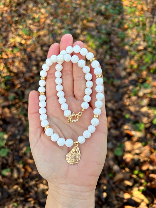 White bead necklace with golden sea shell charm