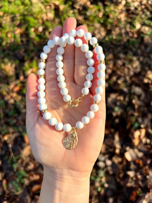White bead necklace with golden sea shell charm