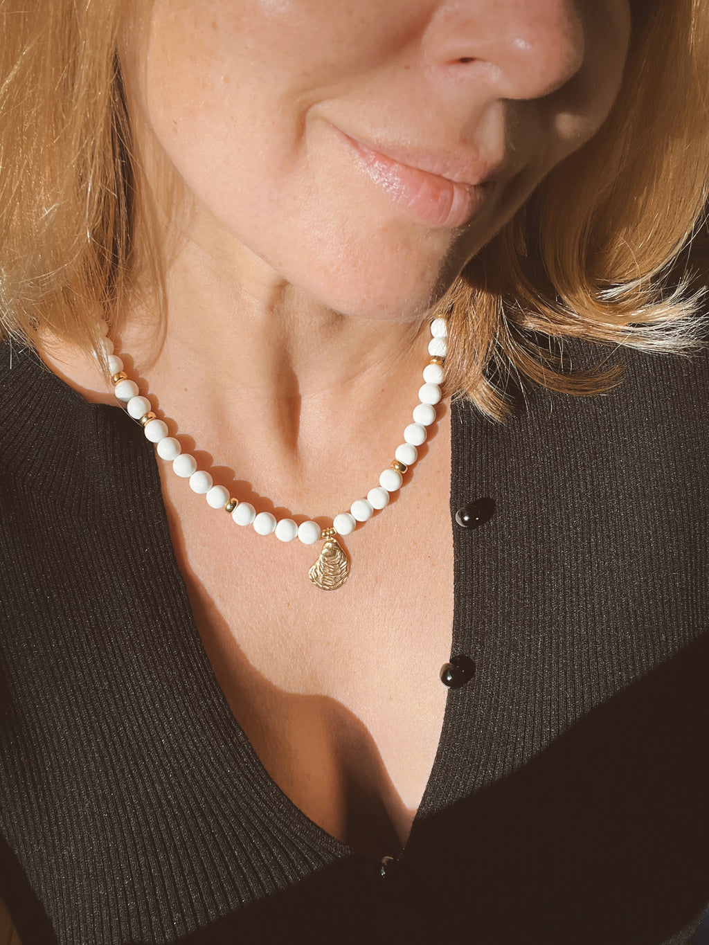 White bead necklace with golden sea shell charm