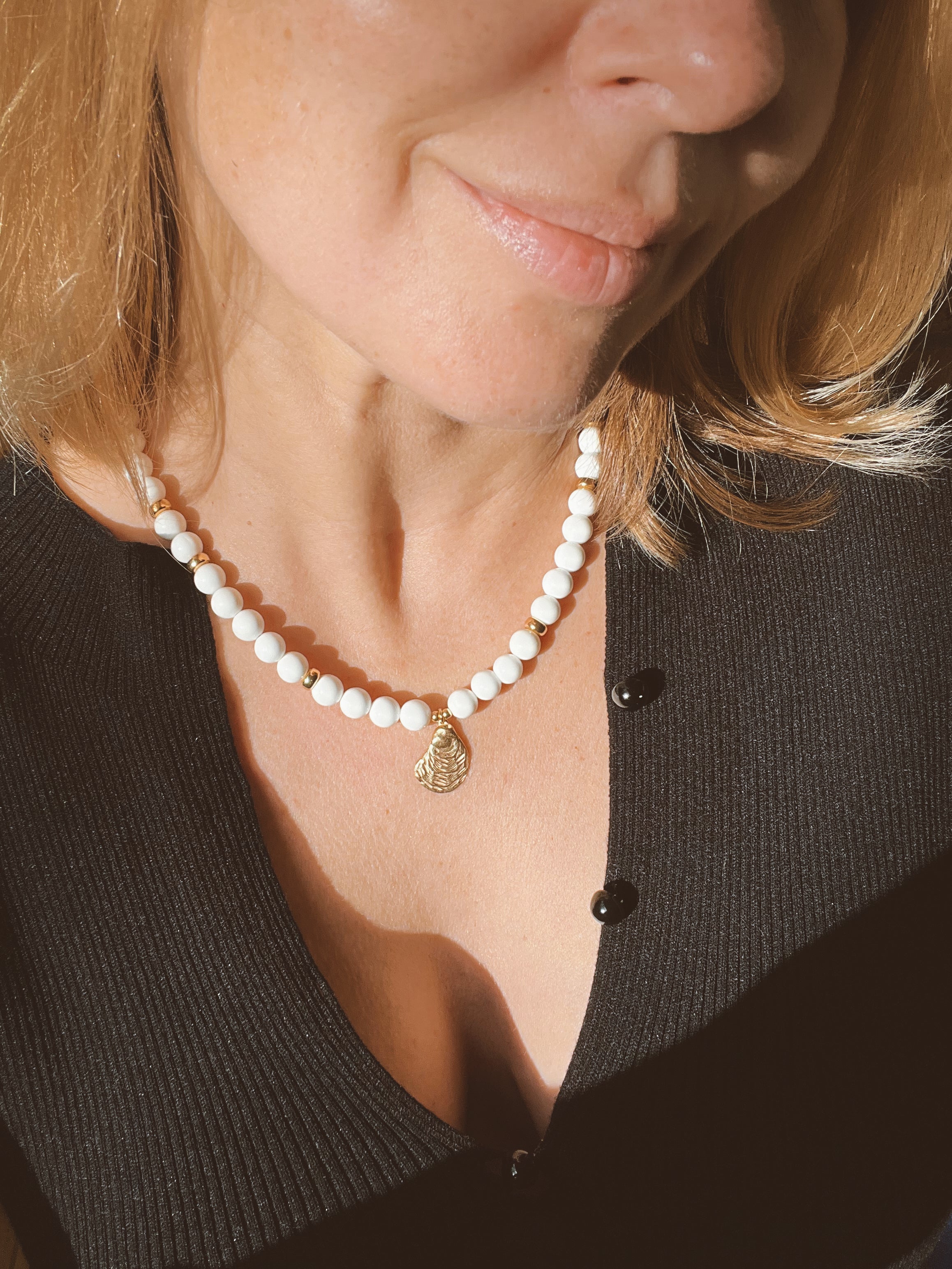 White bead necklace with golden sea shell charm