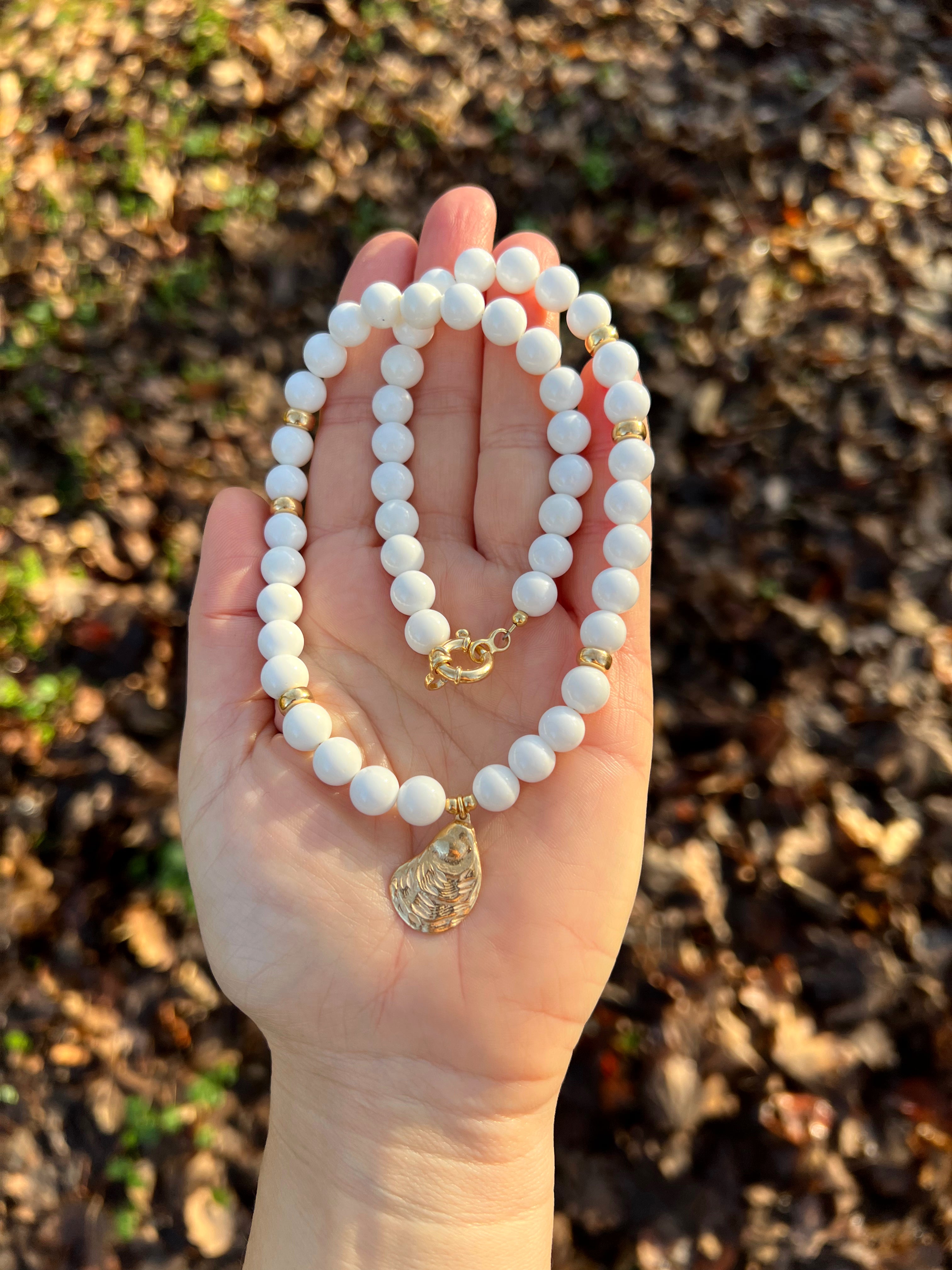 White bead necklace with golden sea shell charm