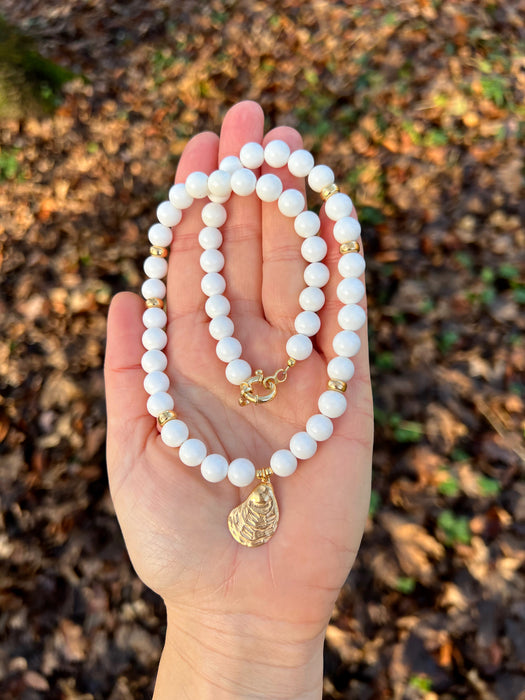 White bead necklace with golden sea shell charm