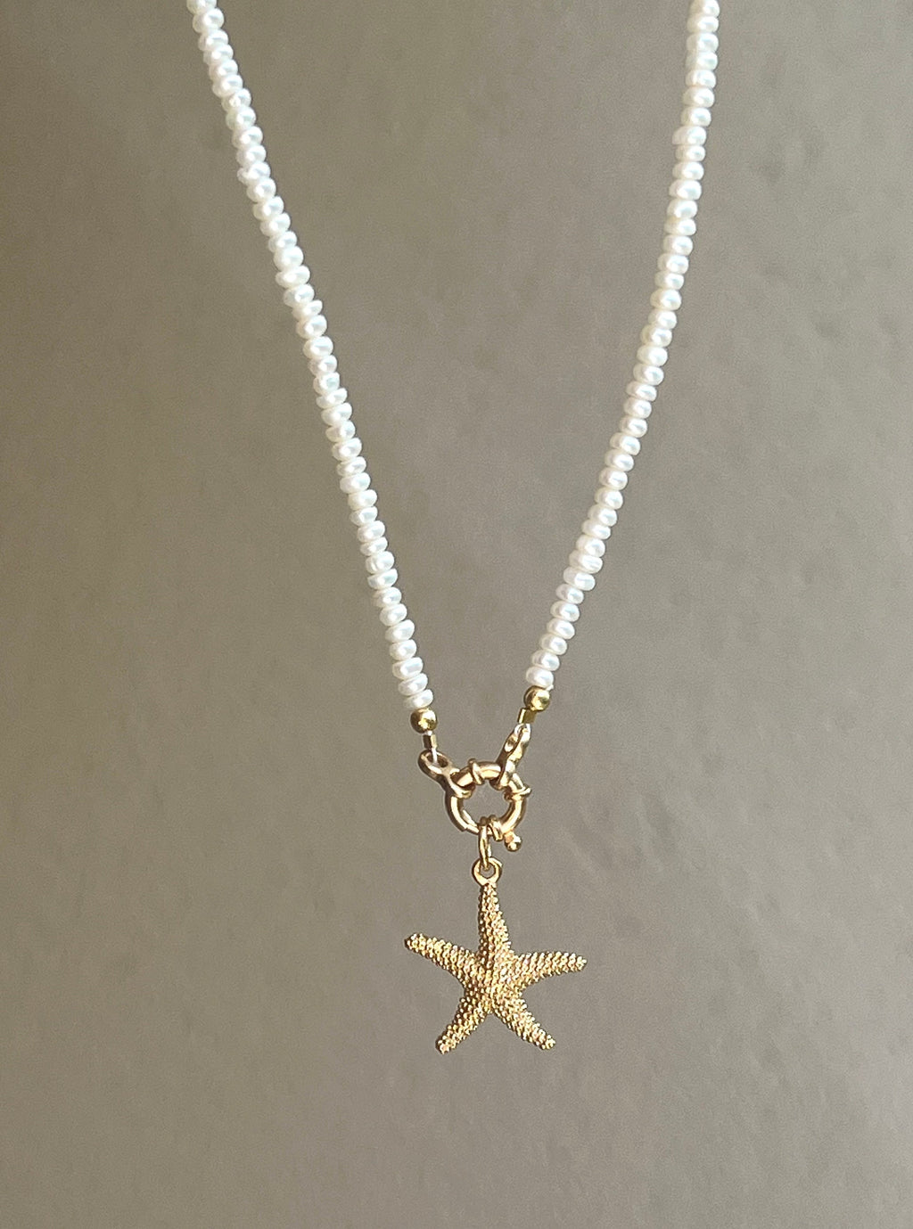 Pearl necklace with golden starfish pendant Beaded Necklaces