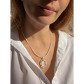 Virgin Mary pendant on pearl chain