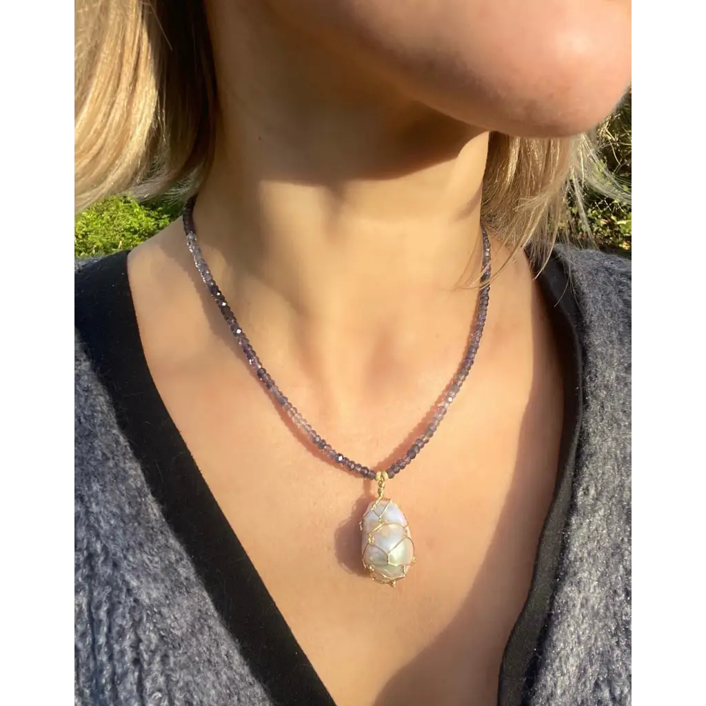 Wire wrapped baroque pearl pendant on iolite beaded necklace