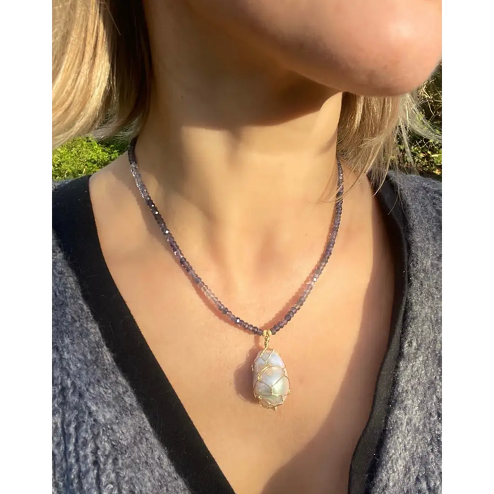 Wire wrapped baroque pearl pendant on iolite beaded necklace
