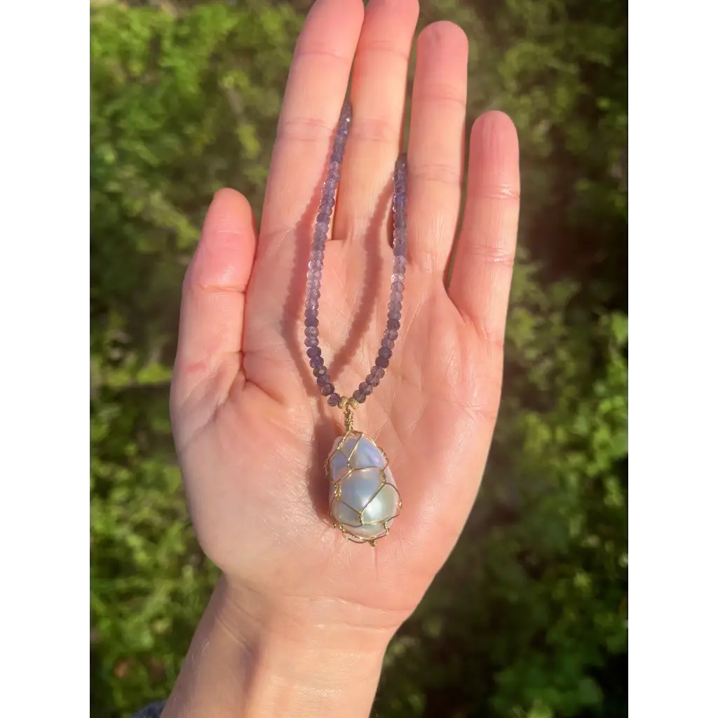 Wire wrapped baroque pearl pendant on iolite beaded necklace
