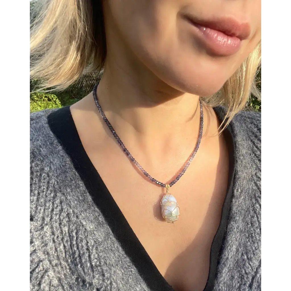 Wire wrapped baroque pearl pendant on iolite beaded necklace