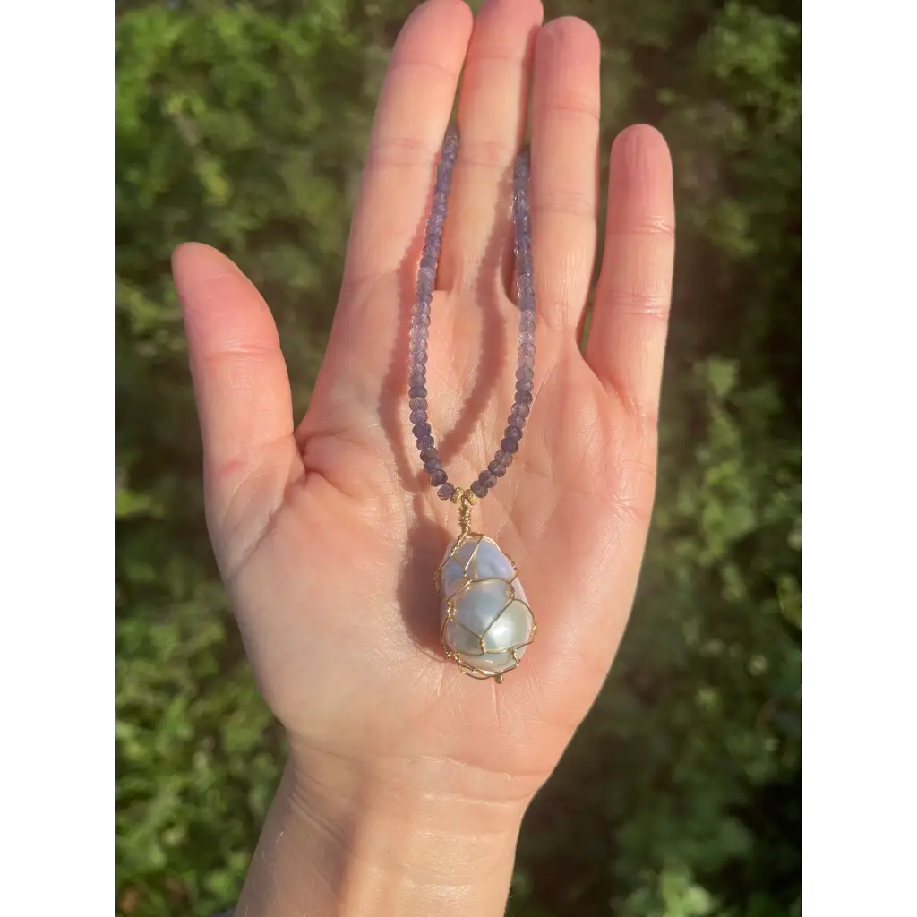 Wire wrapped baroque pearl pendant on iolite beaded necklace
