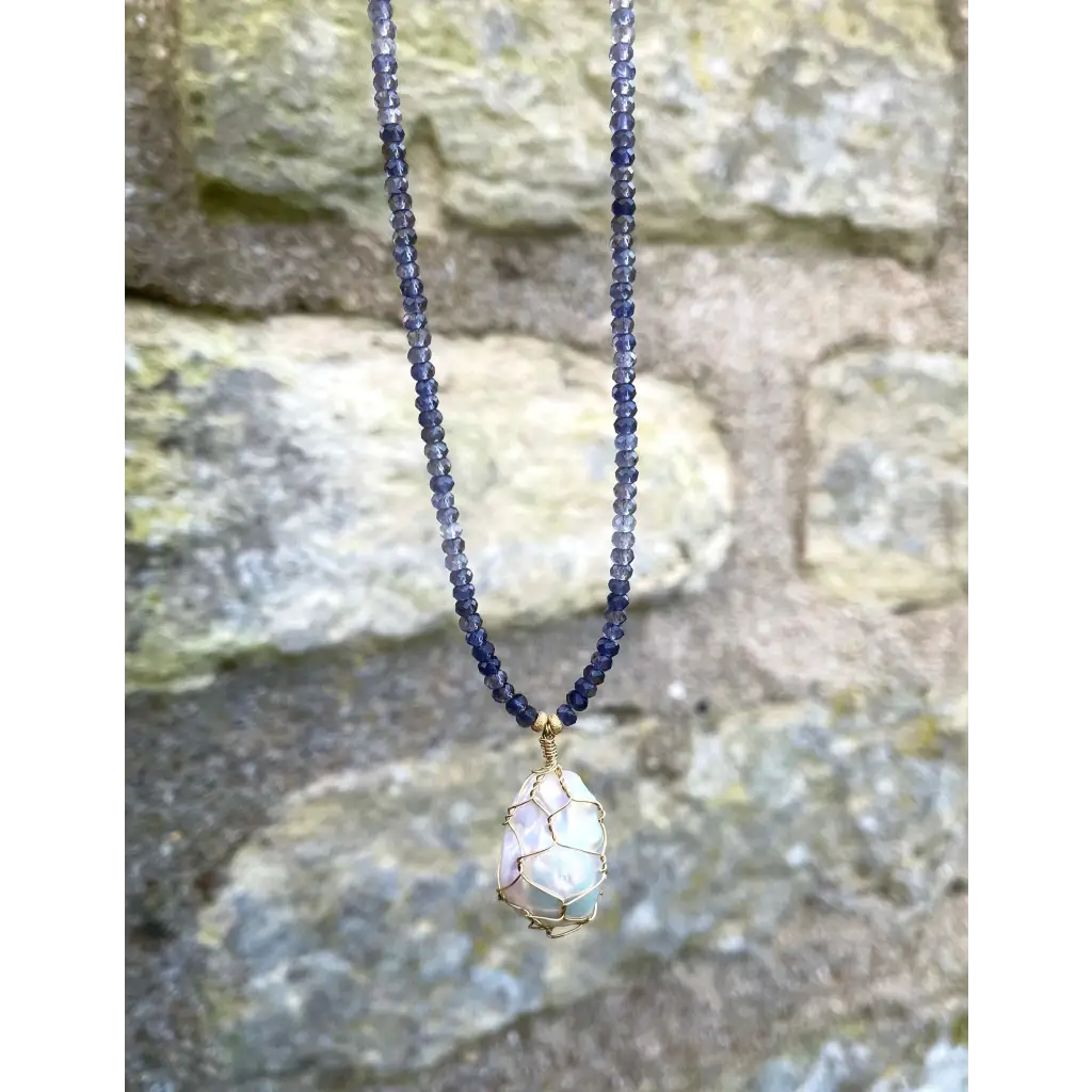 Wire wrapped baroque pearl pendant on iolite beaded necklace