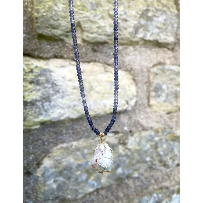 Wire wrapped baroque pearl pendant on iolite beaded necklace