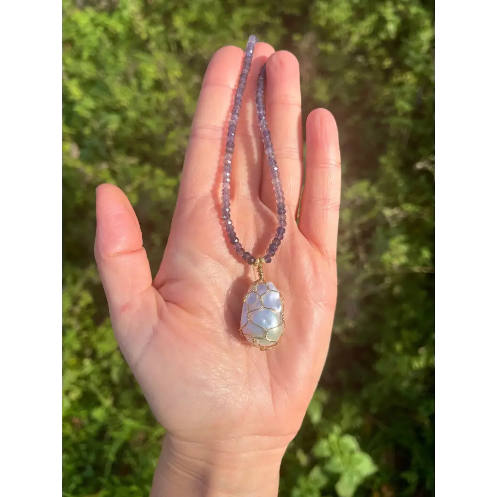 Wire wrapped baroque pearl pendant on iolite beaded necklace