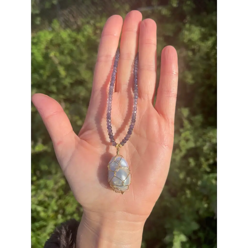 Wire wrapped baroque pearl pendant on iolite beaded necklace