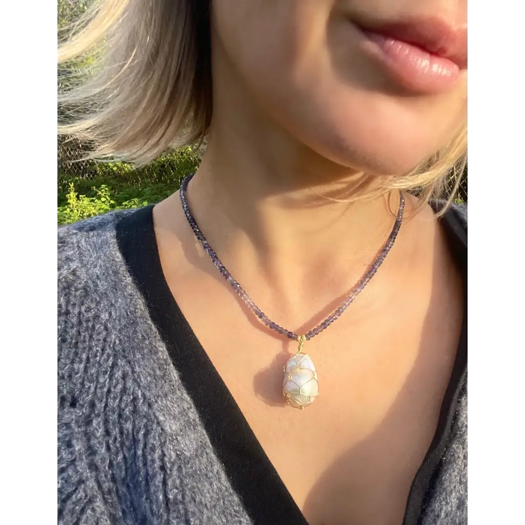 Wire wrapped baroque pearl pendant on iolite beaded necklace
